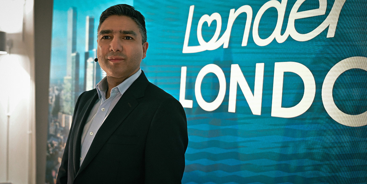 Nick Mohammed as politician Zahar Jaffrey posing next to a campaign poster in Slow Horses season 5.