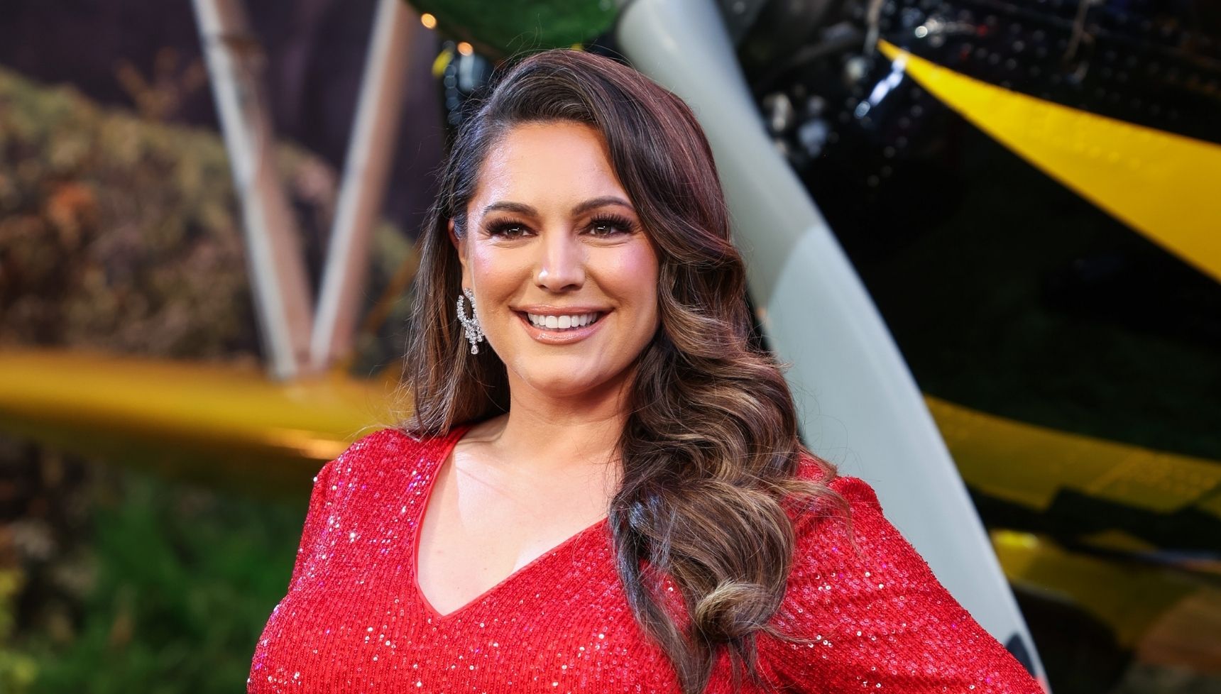Kelly Brook in a red dress smiling