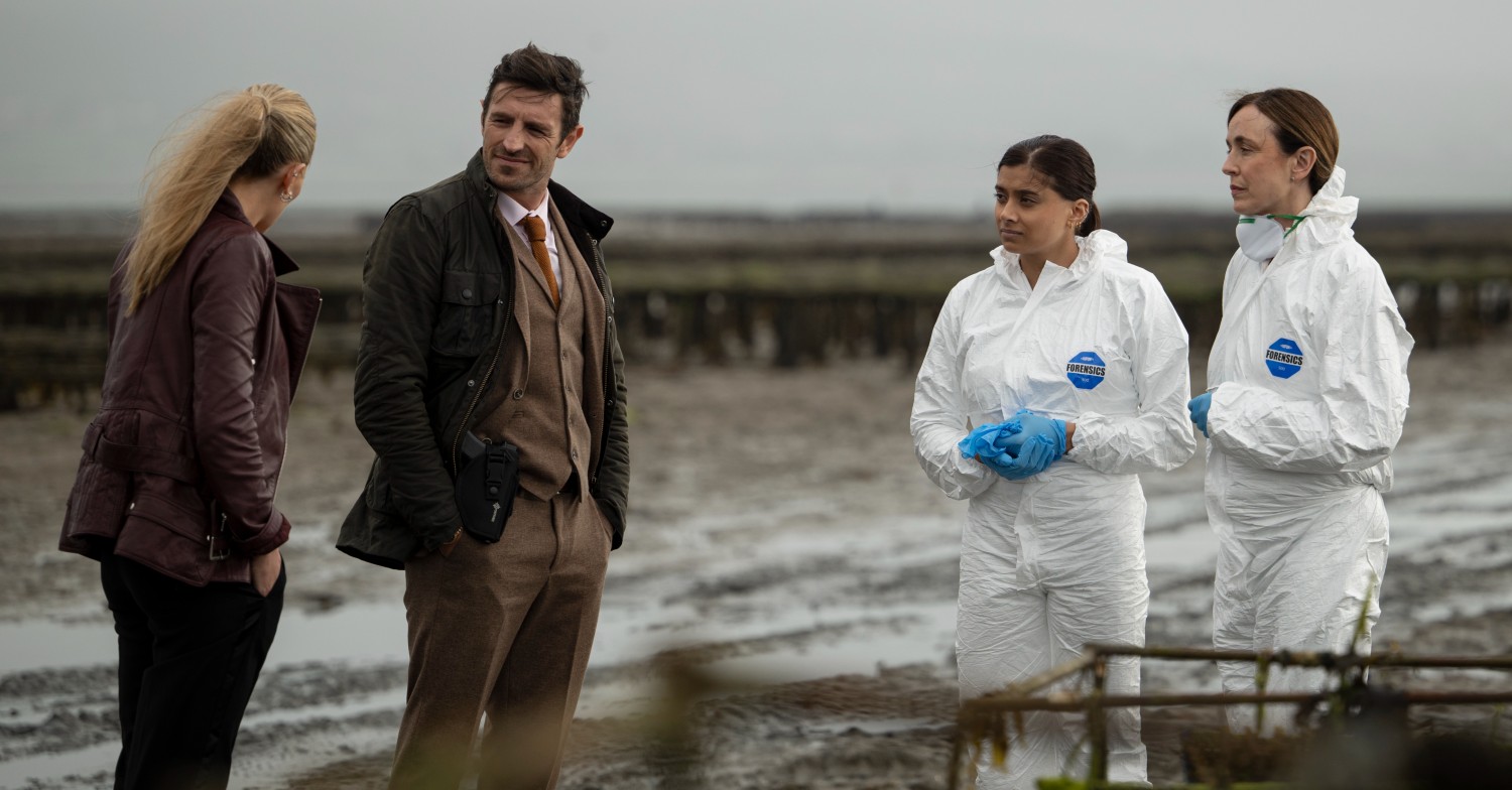 Cast of Borderline filming on a beach