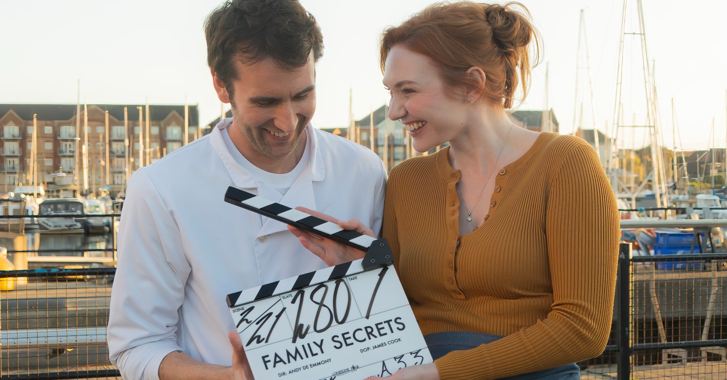 Matthew Lewis and Eleanor Tomlinson with clapperboard for The Family Secret