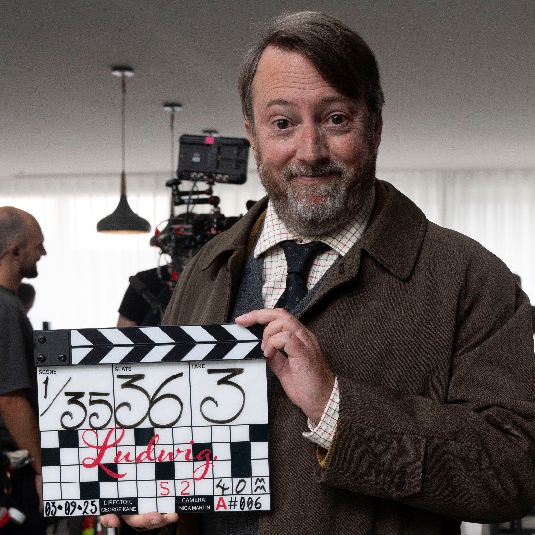 David Mitchell holding up clapper board for Ludwig series 2