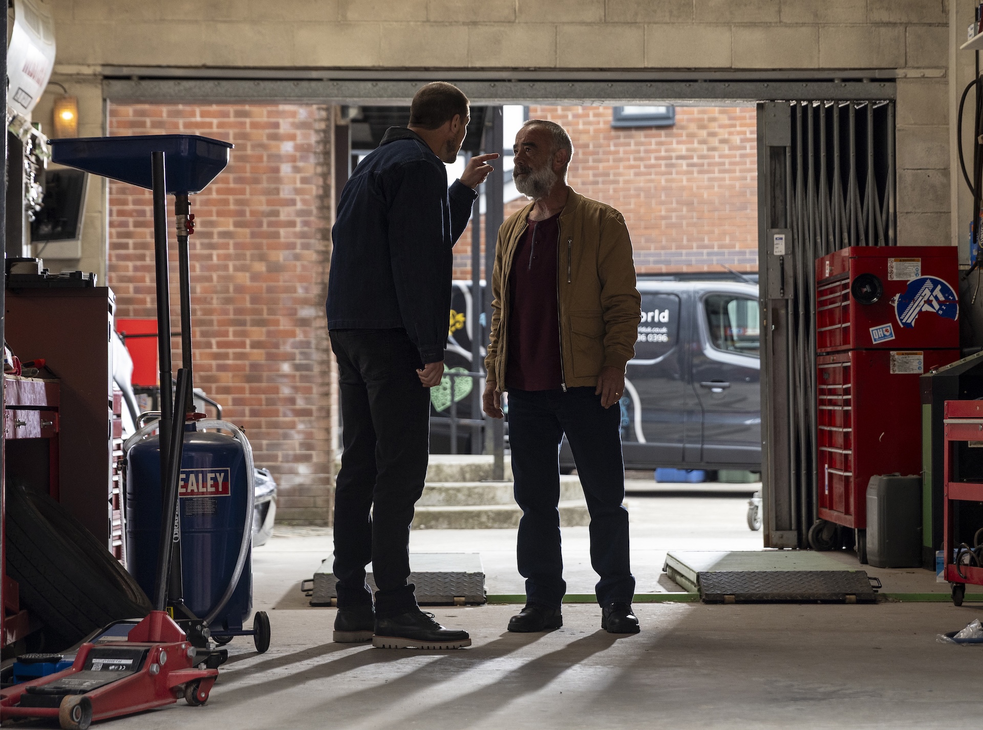 Kevin and Carl arguing in the garage