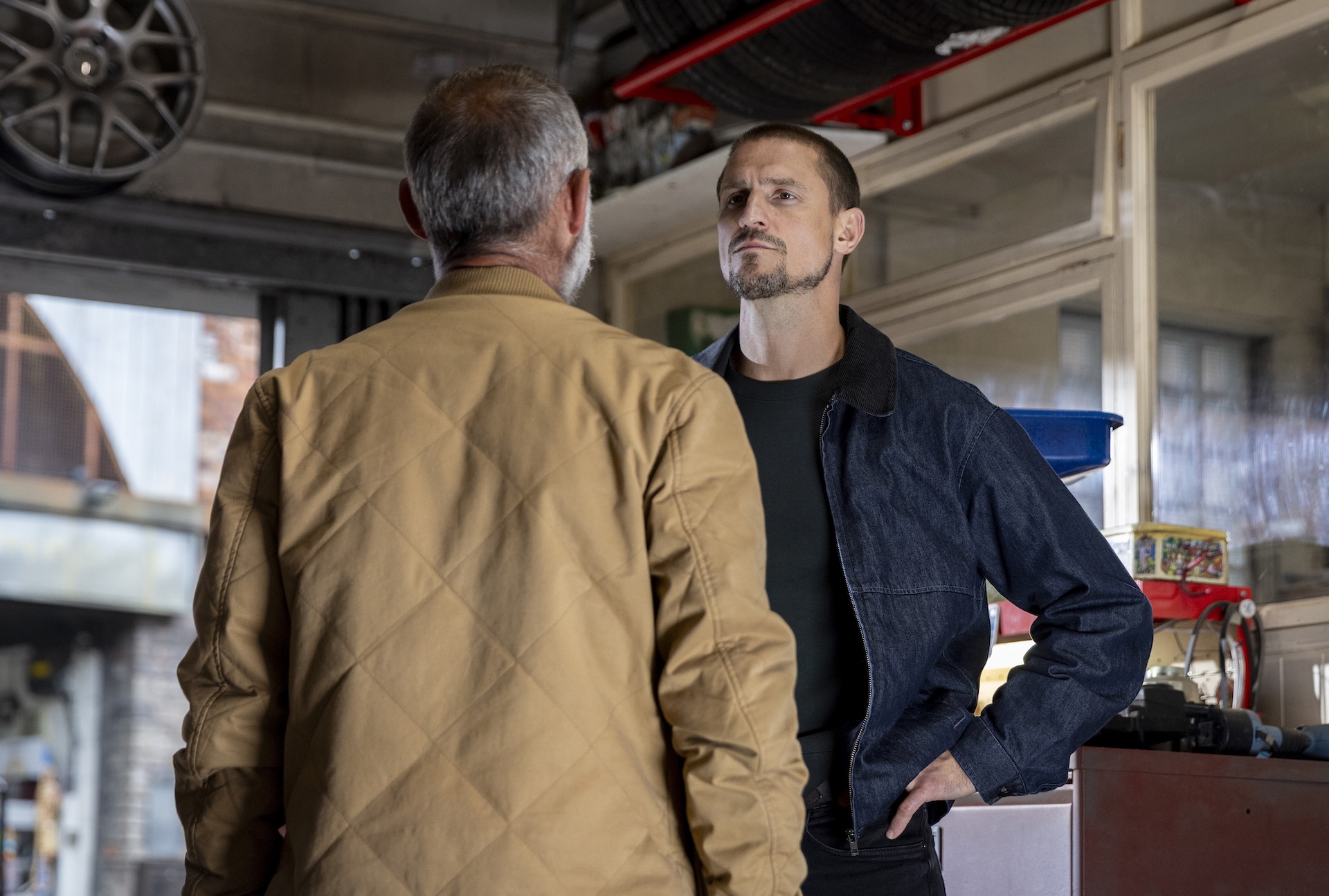 Carl and Kevin talking in the garage