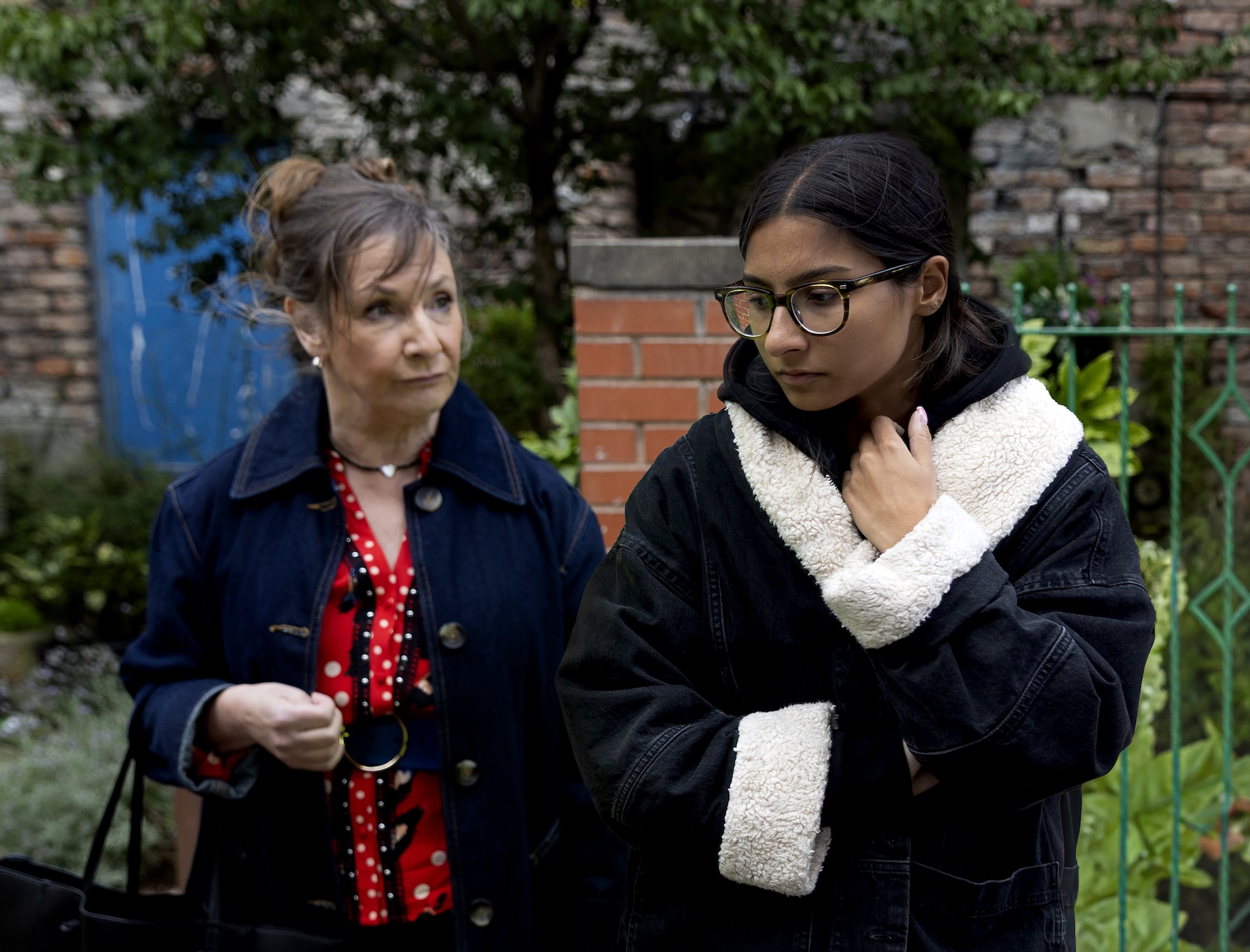 Maggie talking to Asha outside in Coronation Street