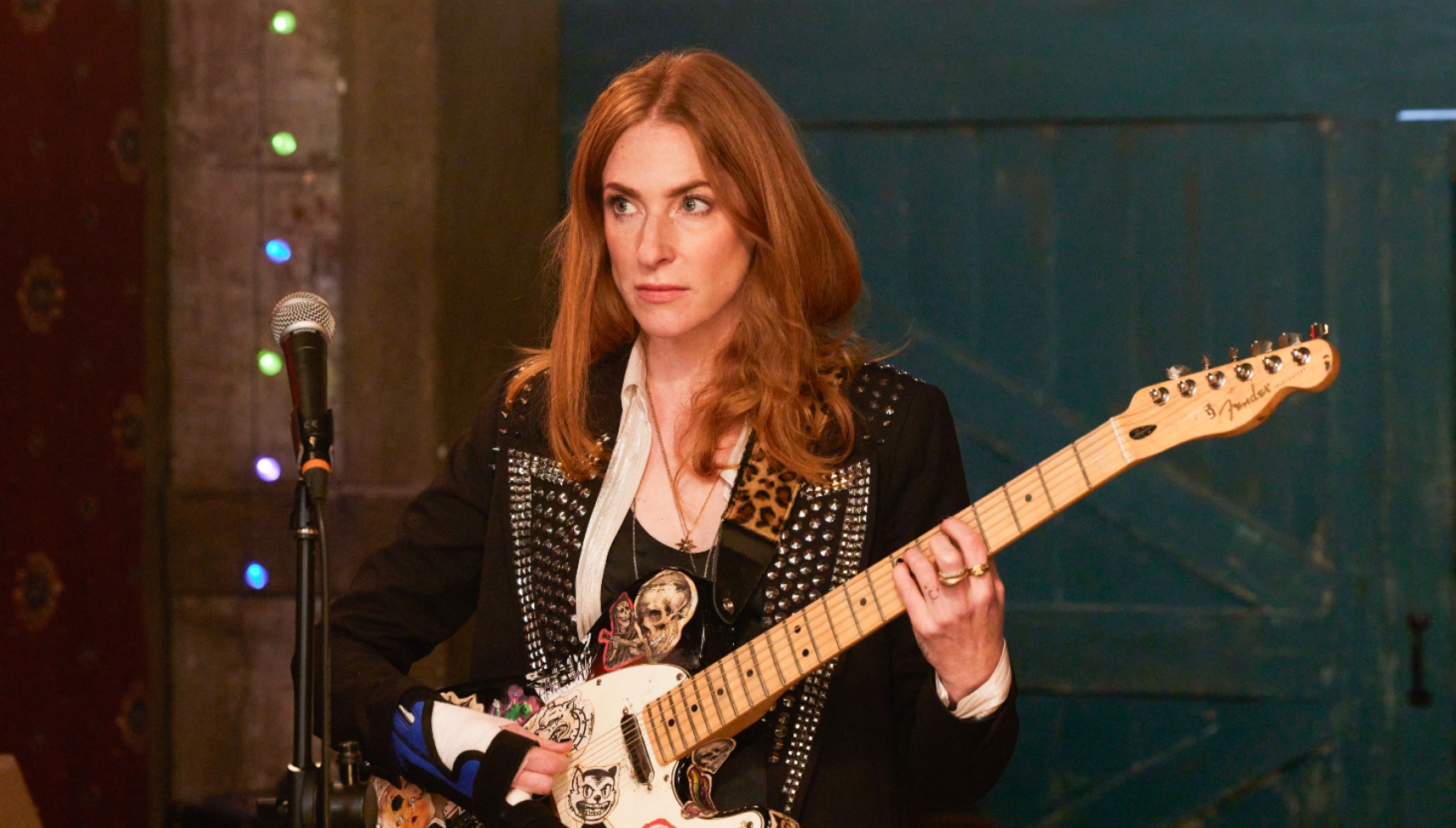 Rosalie Craig as Kitty Eckerson in Riot Women playing the guitar