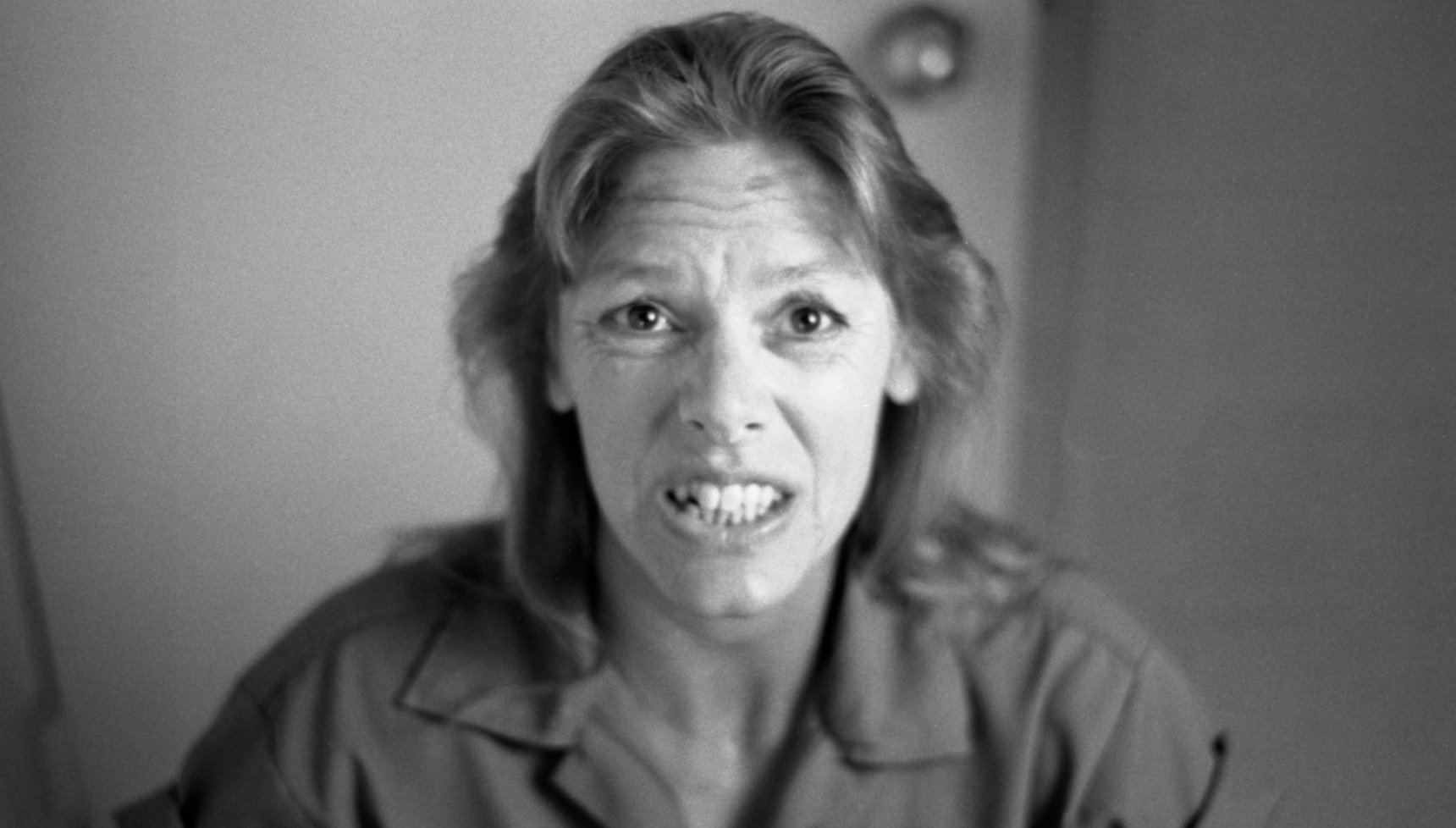 A black and white photograph of Aileen Wuornos in prison clothes