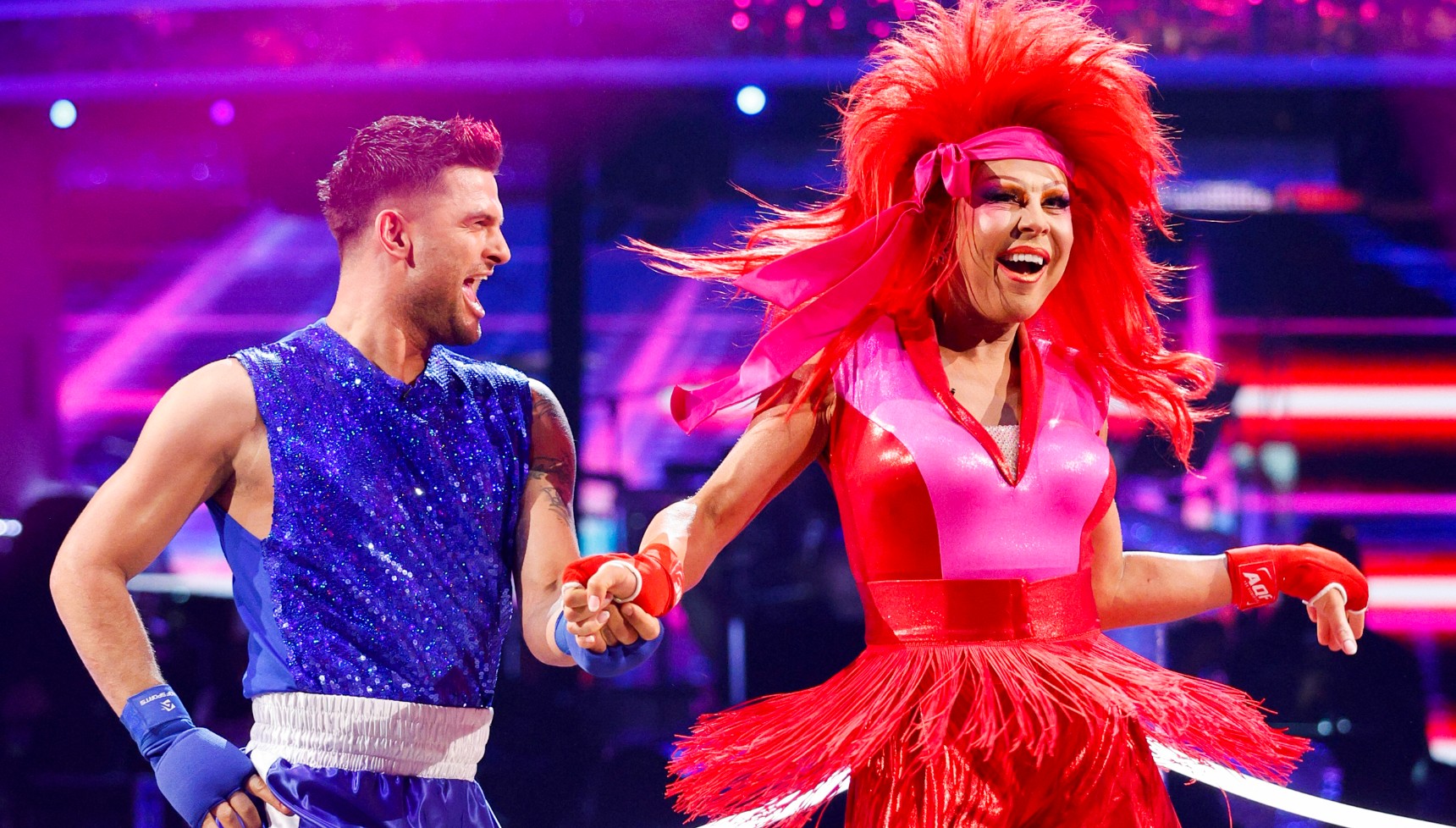 Two colourfully-clothed dancers on the ballroom floor