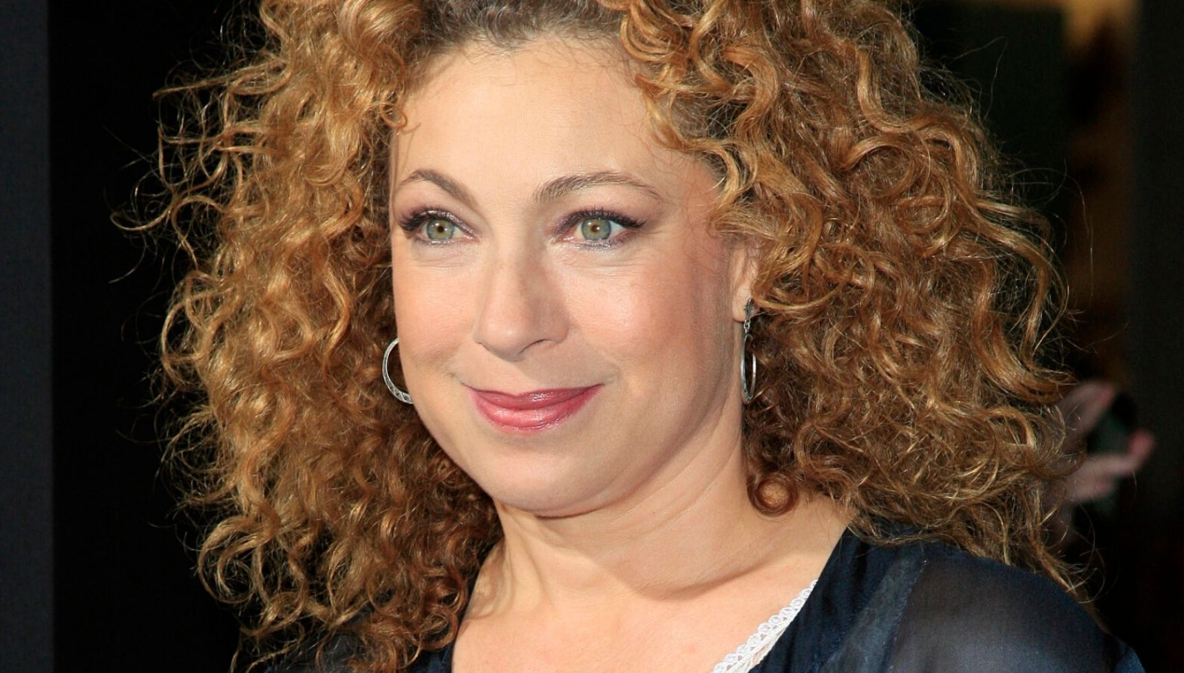 Alex Kingston headshot in black blouse
