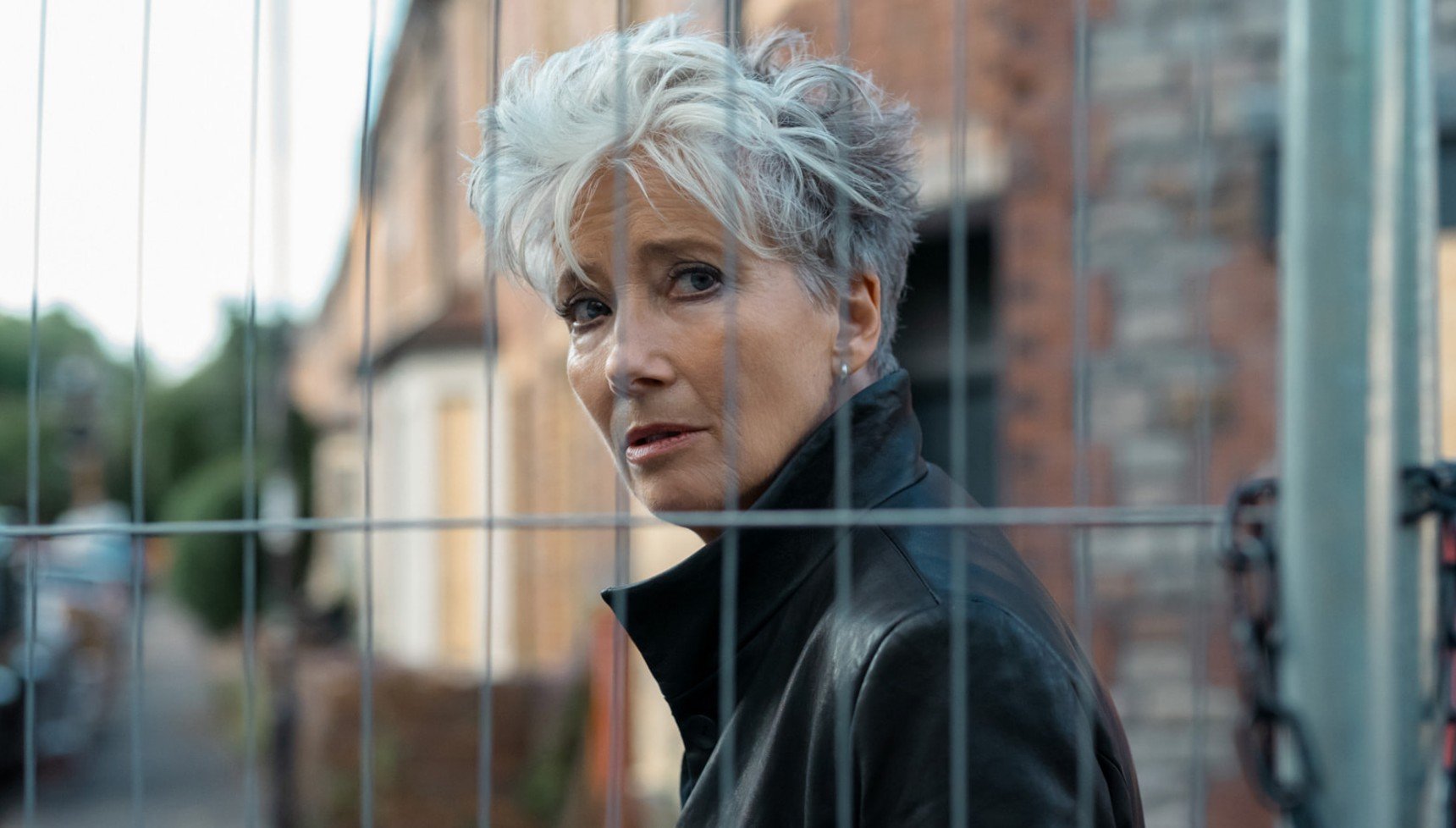 Emma Thompson's Zoë Boehm looks through a metal fence