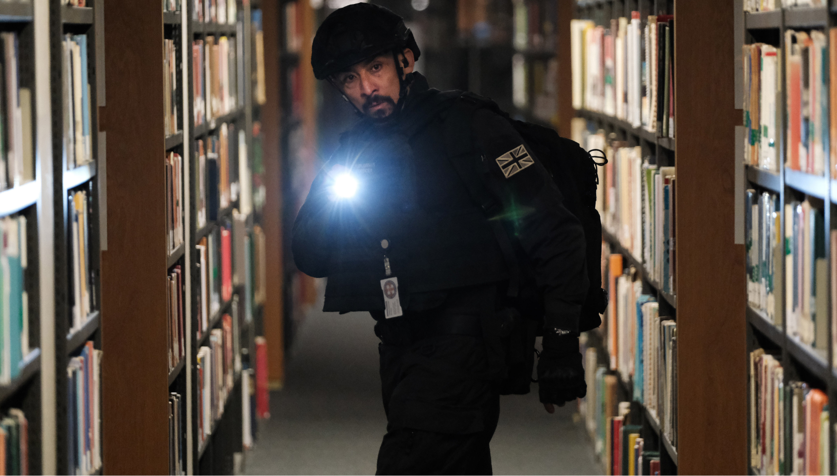 A close up of Nabil Elouahabi carrying a gun in Trigger Point season 3