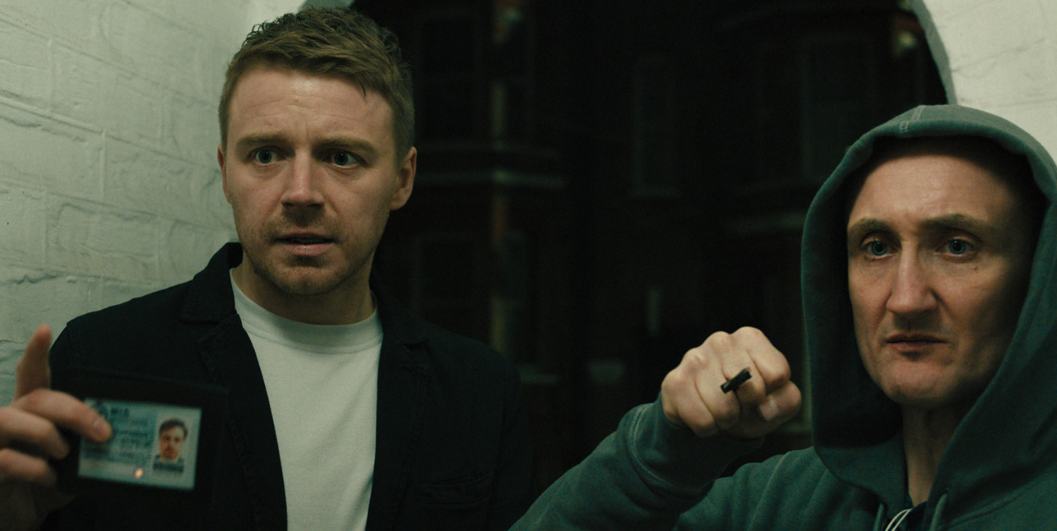 Jack Lowden and Tom Brooke posing with a knife in Slow Horses season 5.