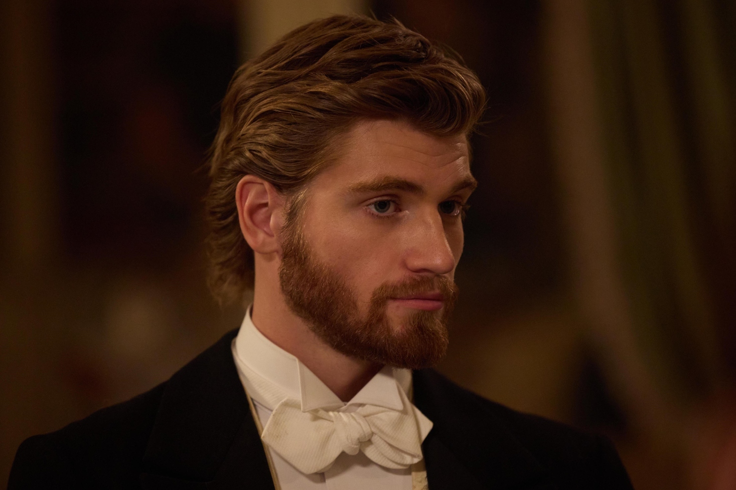 Danny Griffin As Joylon in The Forsytes wearing a dark suit and a while bowtie
