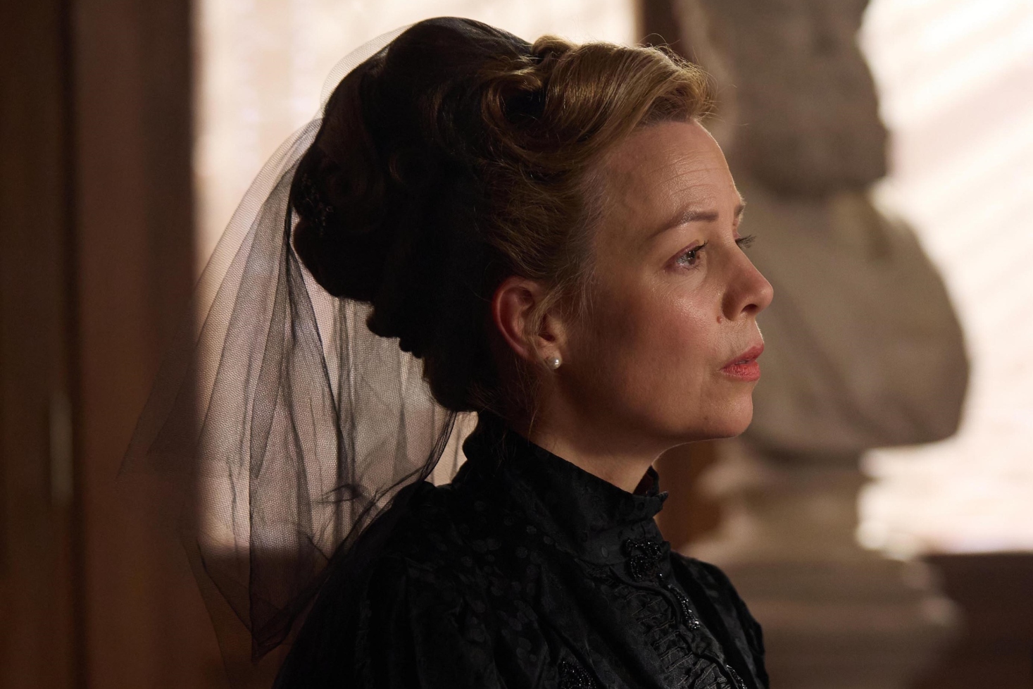 Fiona Button as Mrs Heron wearing black mourning clothes