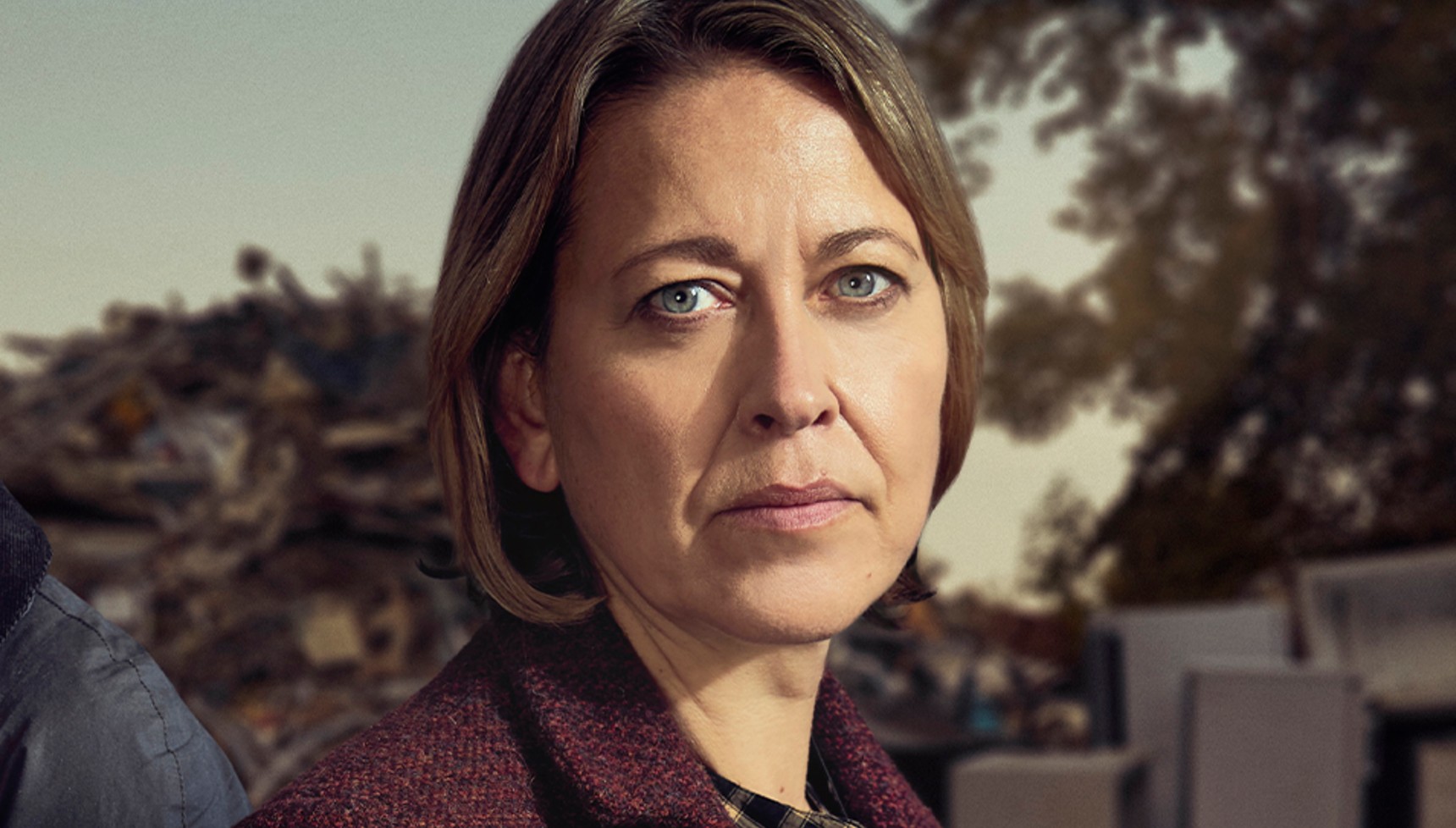 Brunette woman in a maroon-coloured jacket