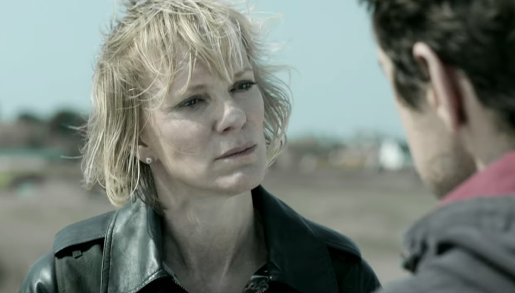 A blonde woman looks into the eyes of a black-haired man in A Mother's Son