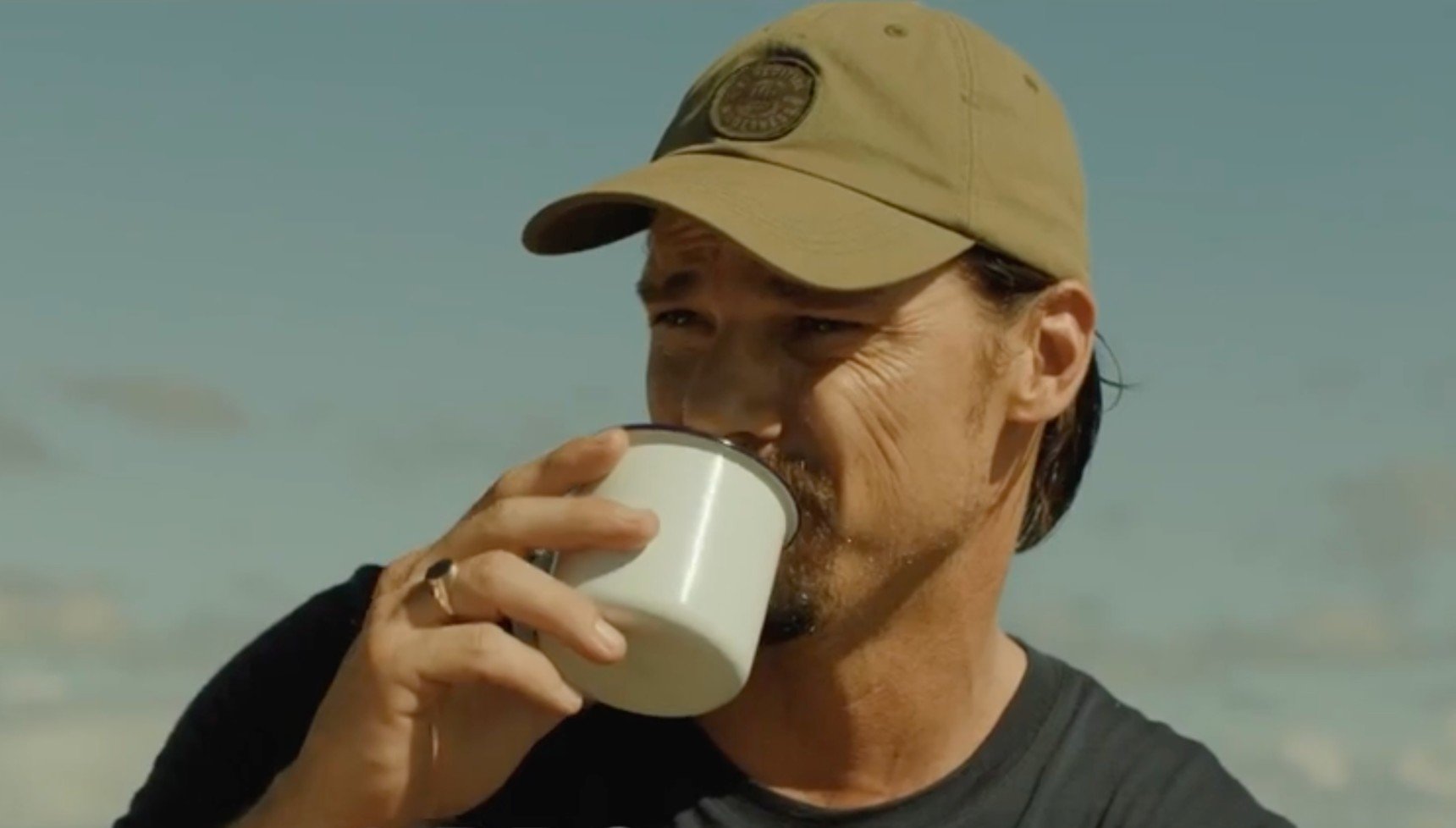 Ewan drinking from the drugged tea in The Ridge