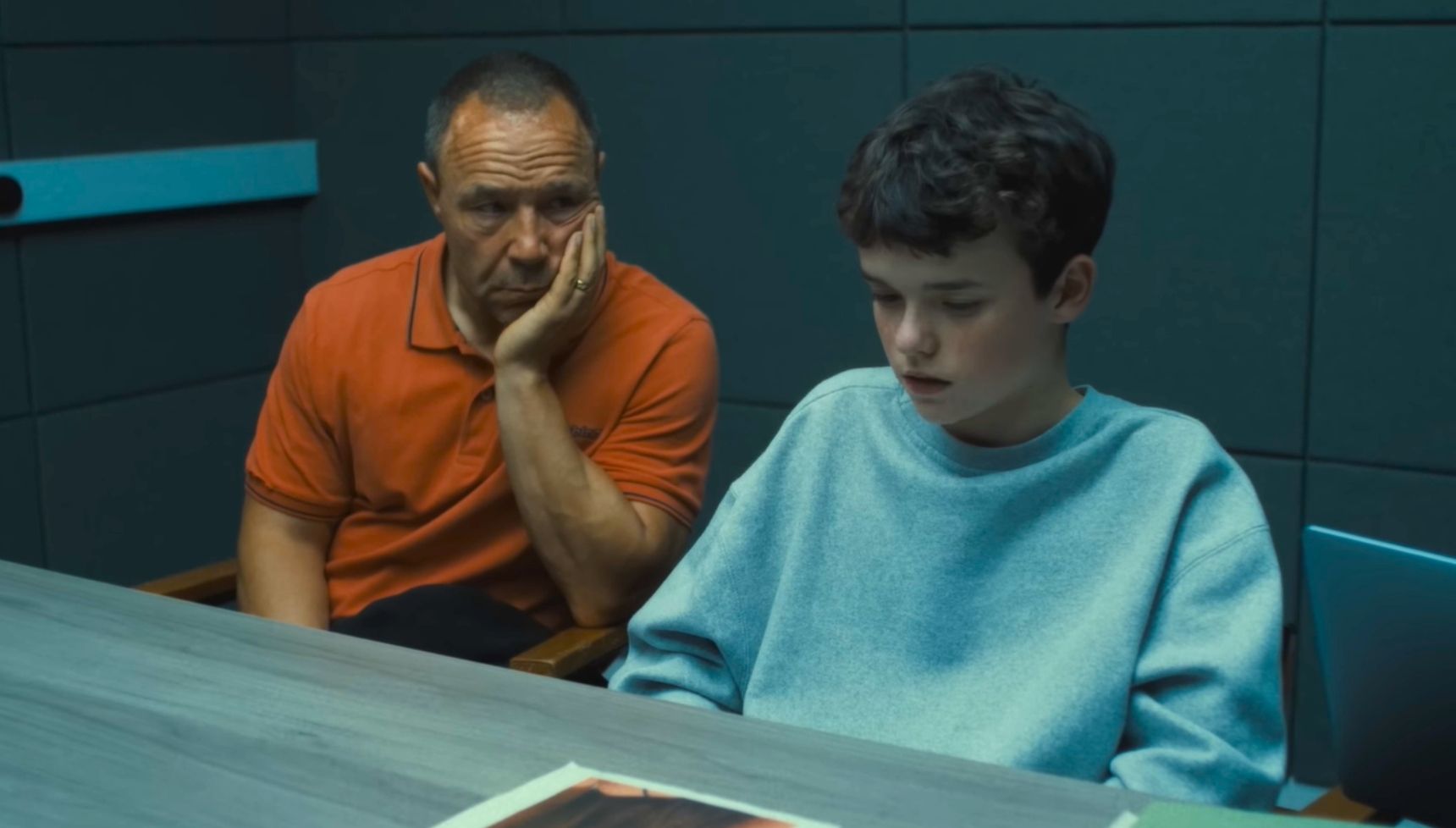 Stephen Graham sitting next to Owen Cooper in an interrogation room in Adolescence