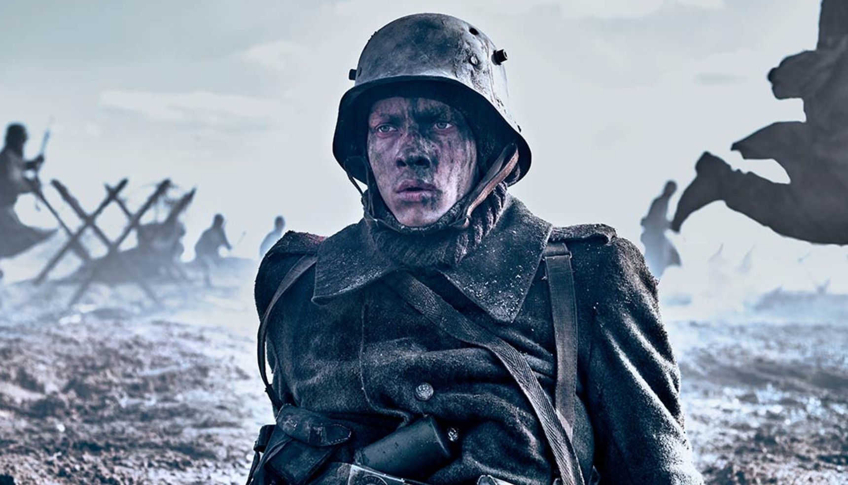 A soldier covered in mud and ash on the battlefield in All Quiet on the Western Front