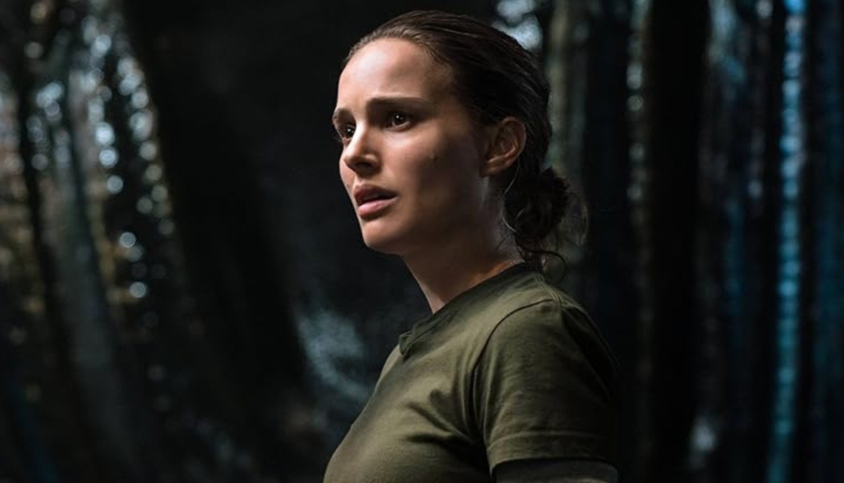 Natalie Portman in a green t-shirt staring into the distance in Annihilation
