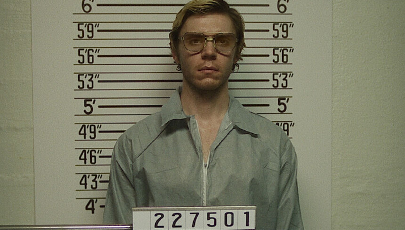 Evan Peters as Jeffrey Dahmer getting his mug shot
