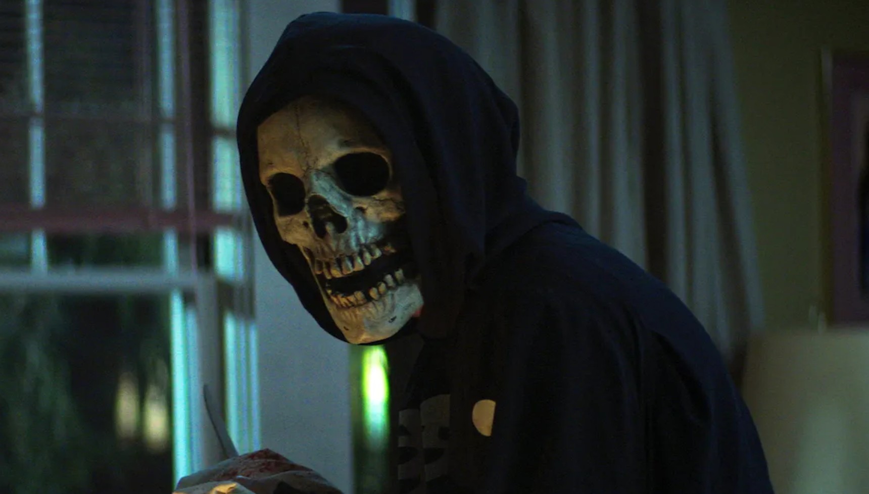 A man in a skull mask and black hoodie in the Fear Street franchise