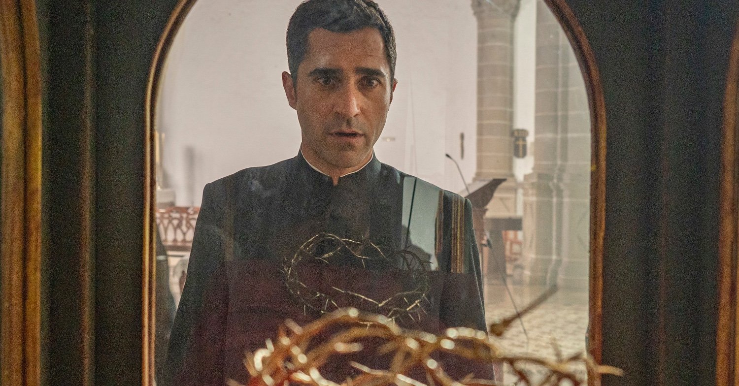 Frauds priest looks at the crown of thorns