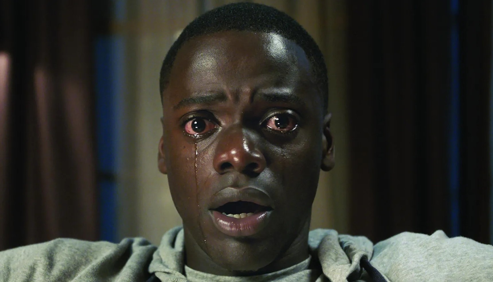 Daniel Kaluuya crying and staring ahead in Get Out