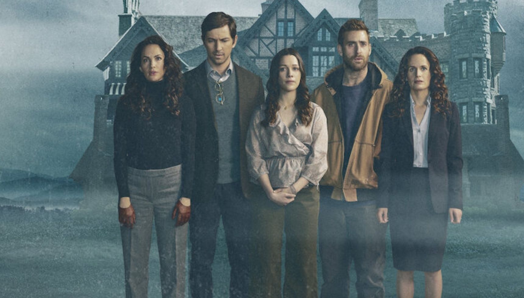 The cast of The Haunting of Hill House standing in front of the house