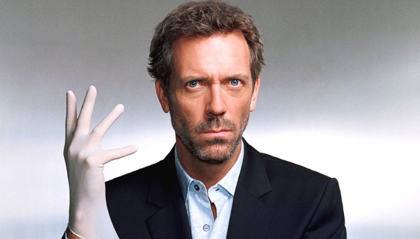 Hugh Laurie's House wearing a medical glove in House