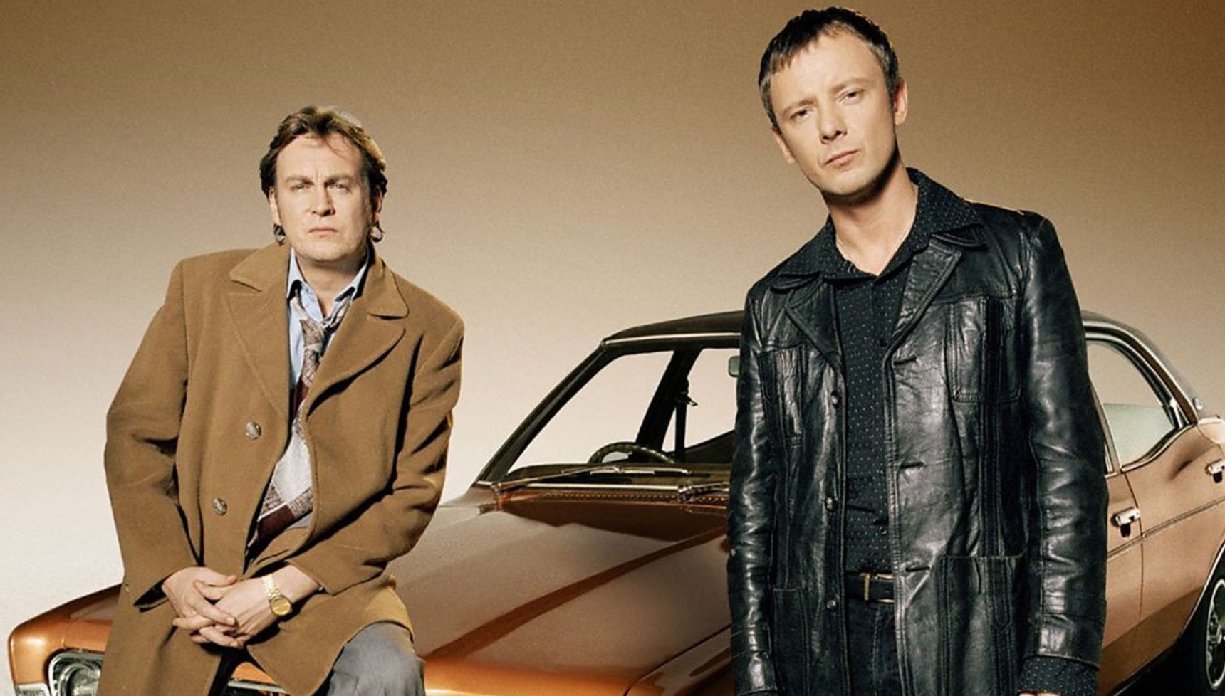 Philip Glenister and John Simm standing in front of a car in Life of Mars