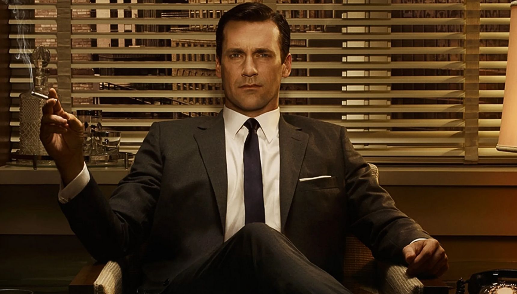 Don Draper sitting with a cigarette in Mad Men