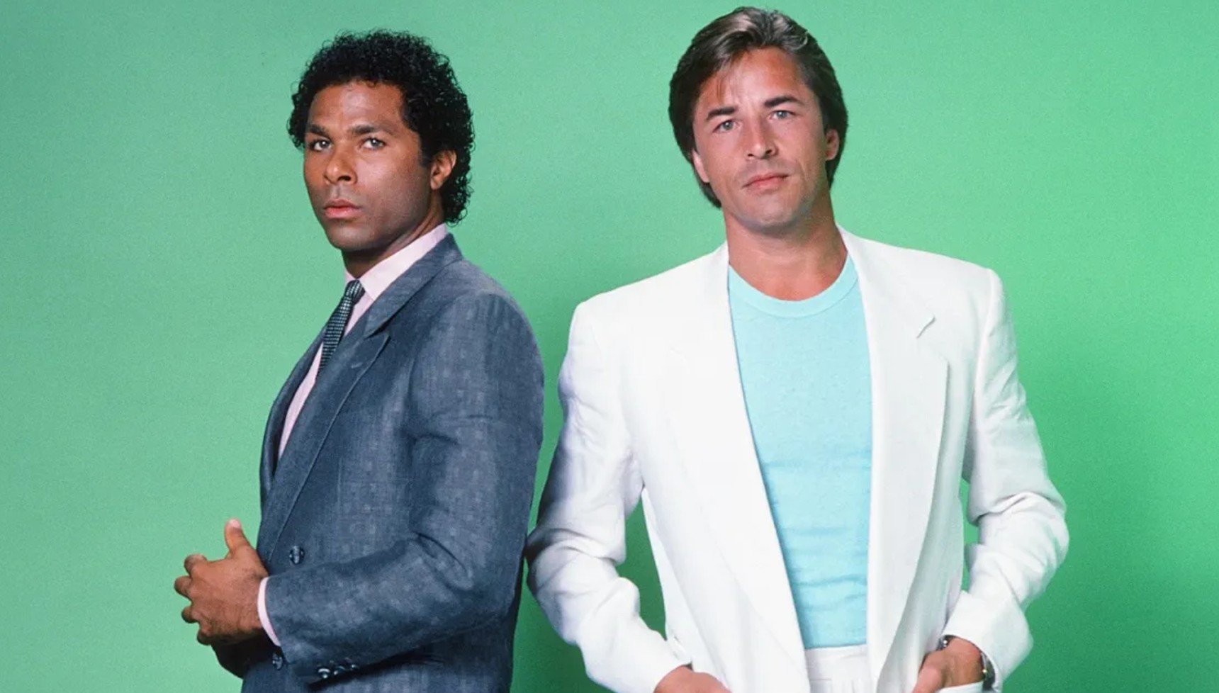 Tubbs and Crockett standing next to each other against a green background in Miami Vice