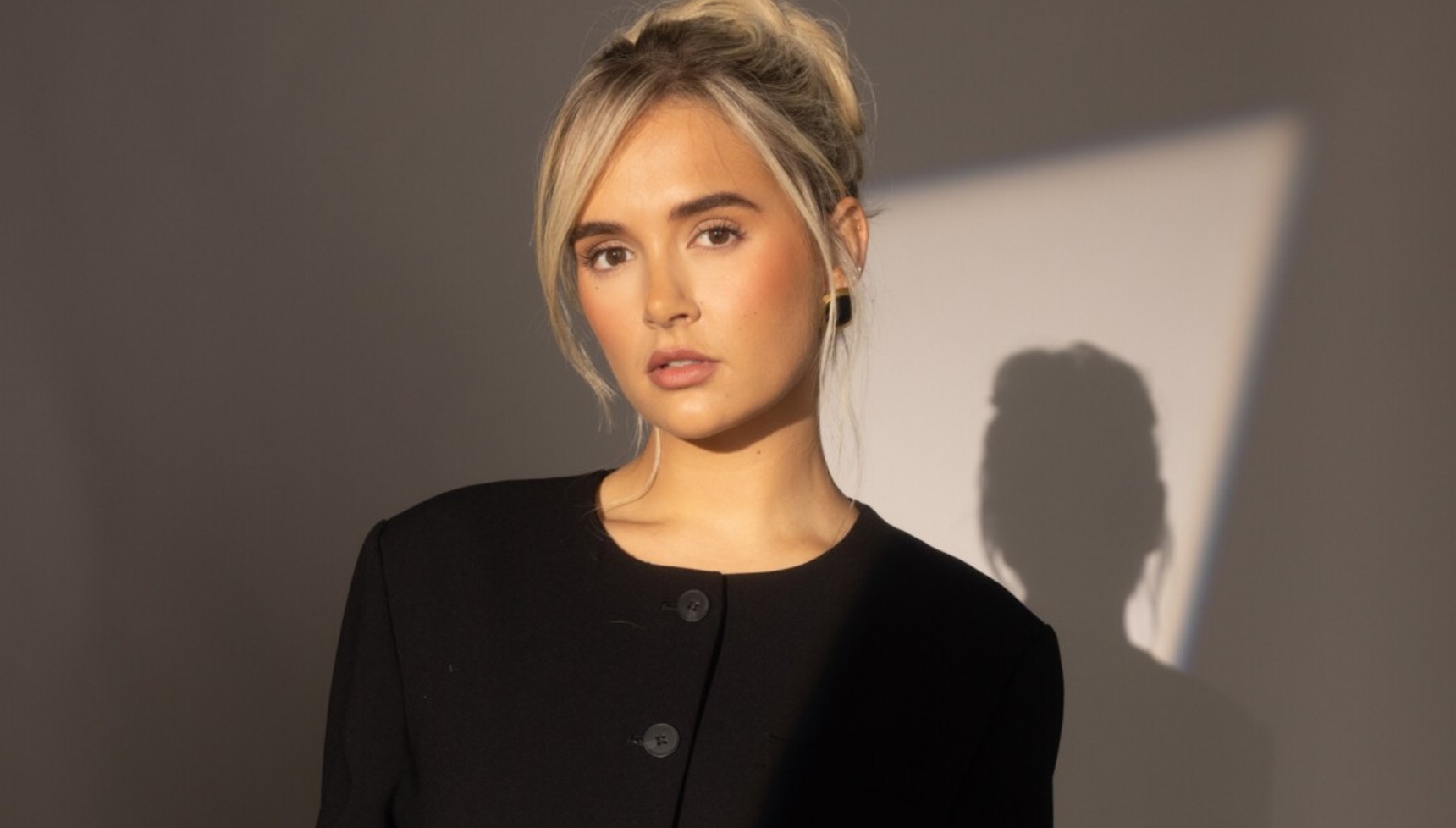 Molly-Mae with her shadow on the wall behind her