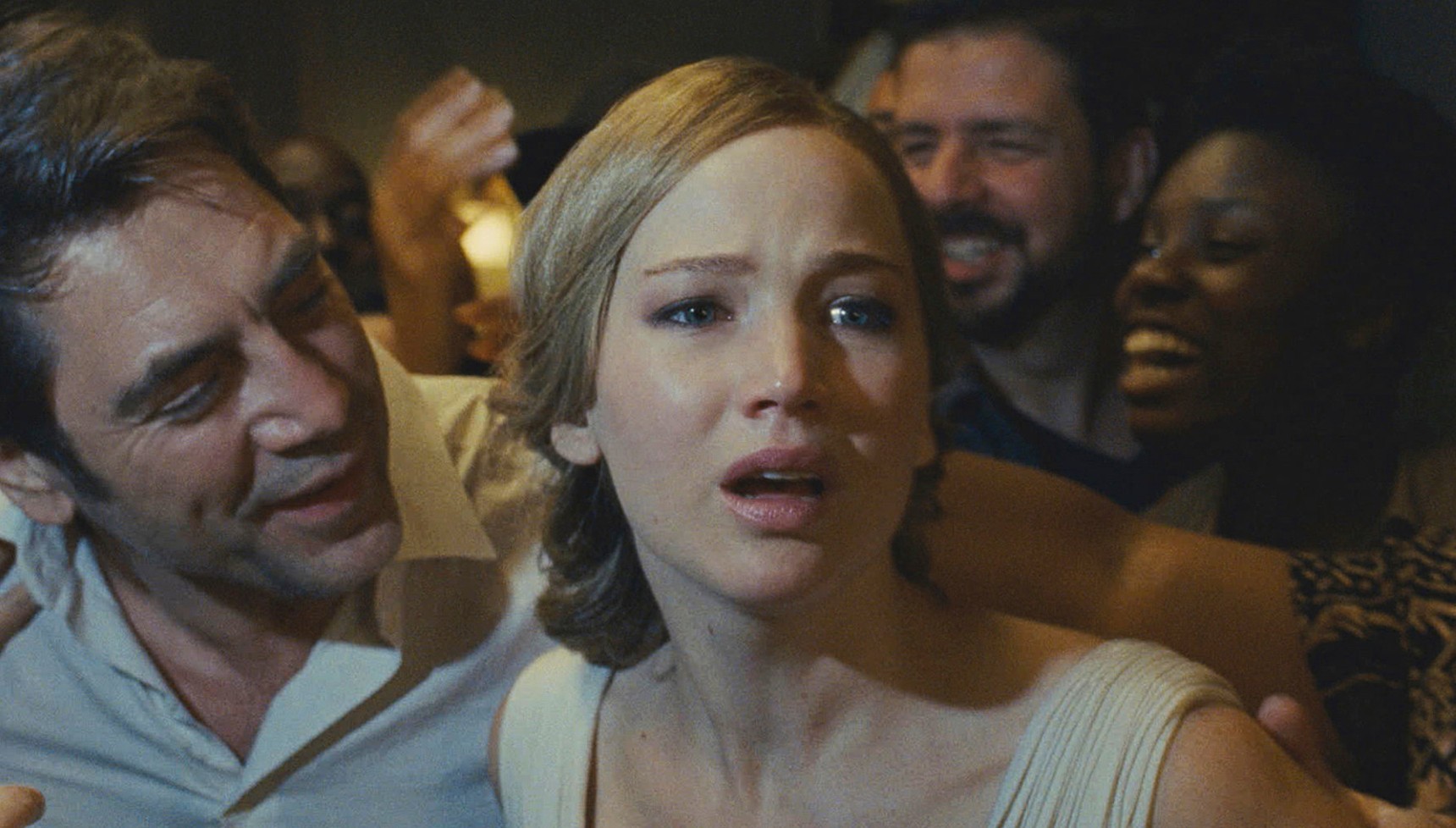 Javier Bardem smiling at Jennifer Lawrence as she looks stressed in Mother