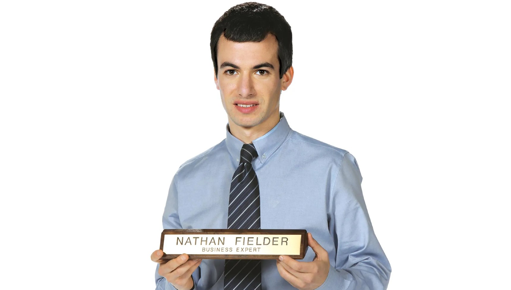Nathan Fielder holding a "business expert" sign in Nathan For You