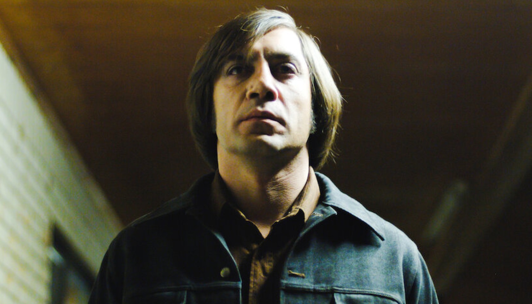 Javier Bardem standing alone in No Country for Old Men