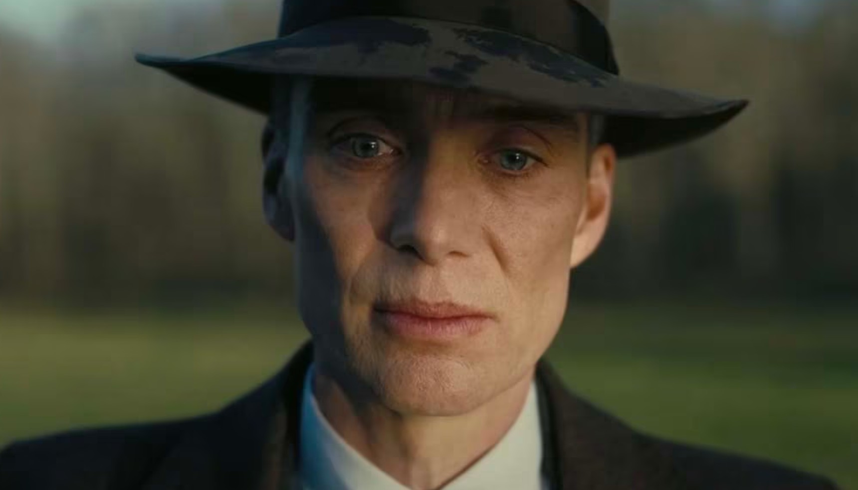 Cillian Murphy wearing a hat and looking pensive in Oppenheimer