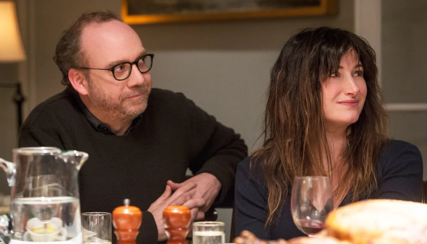 Paul Giamatti and Kathryn Hahn sitting at a table in Private Life