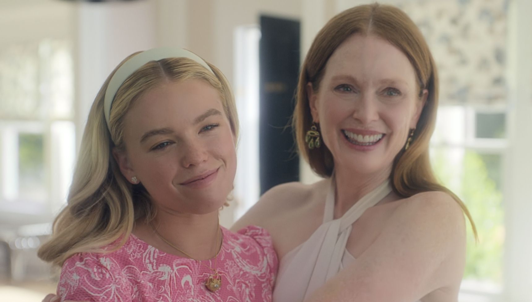 Milly Alcock and Julianne Moore hugging and smiling in Sirens