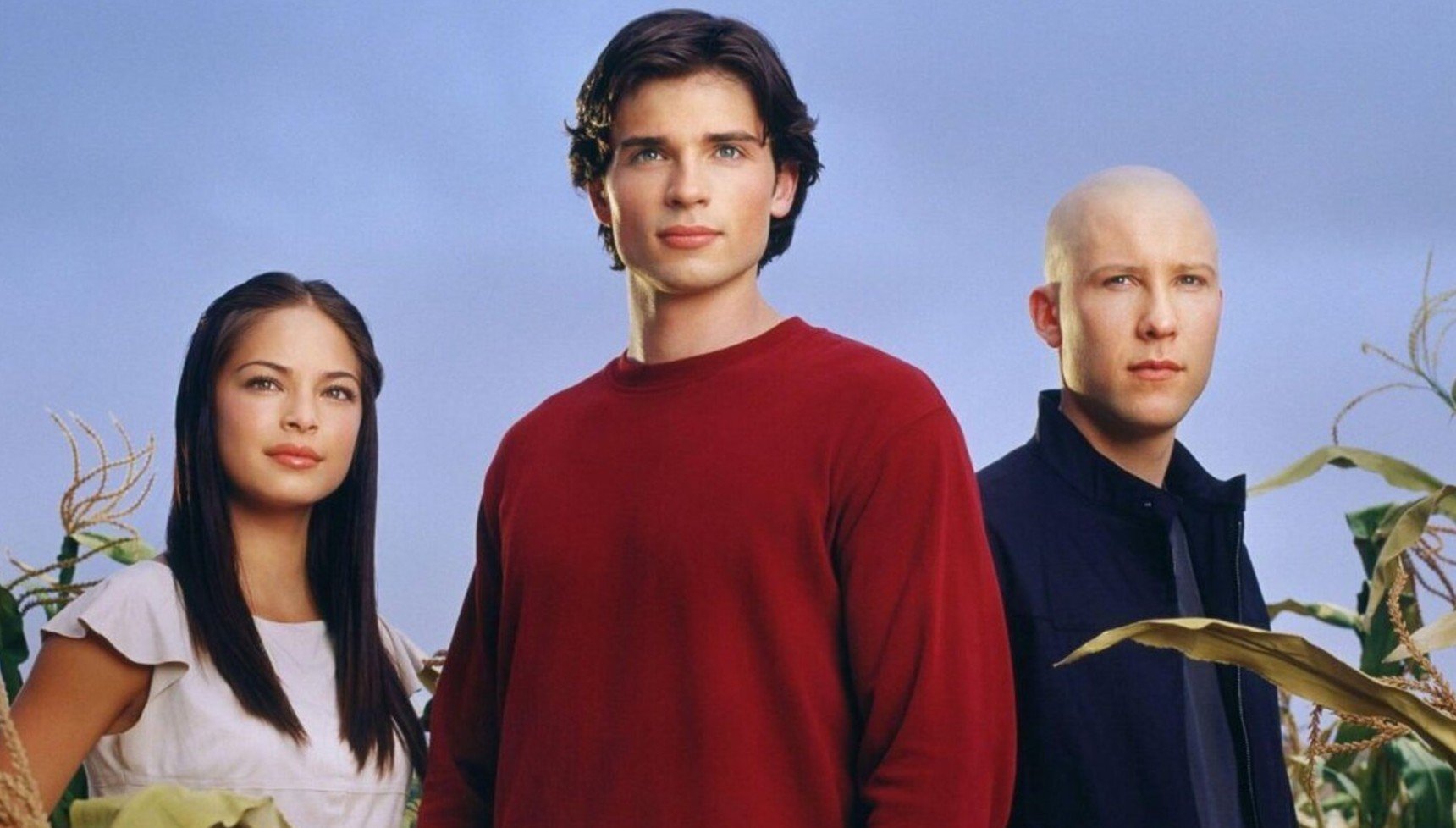 Kristin Kreuk, Tom Welling, and Michael Rosenbaum standing next to each other in a promotional image for Smallville