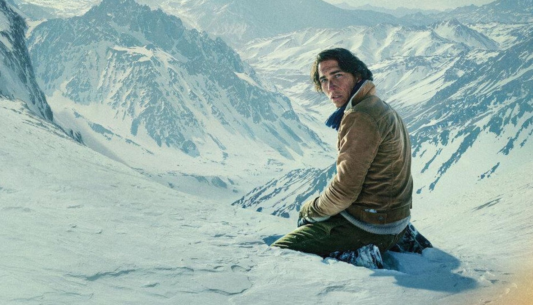 Enzo Vogrincic kneeling in the snow on the poster for Society of the Snow
