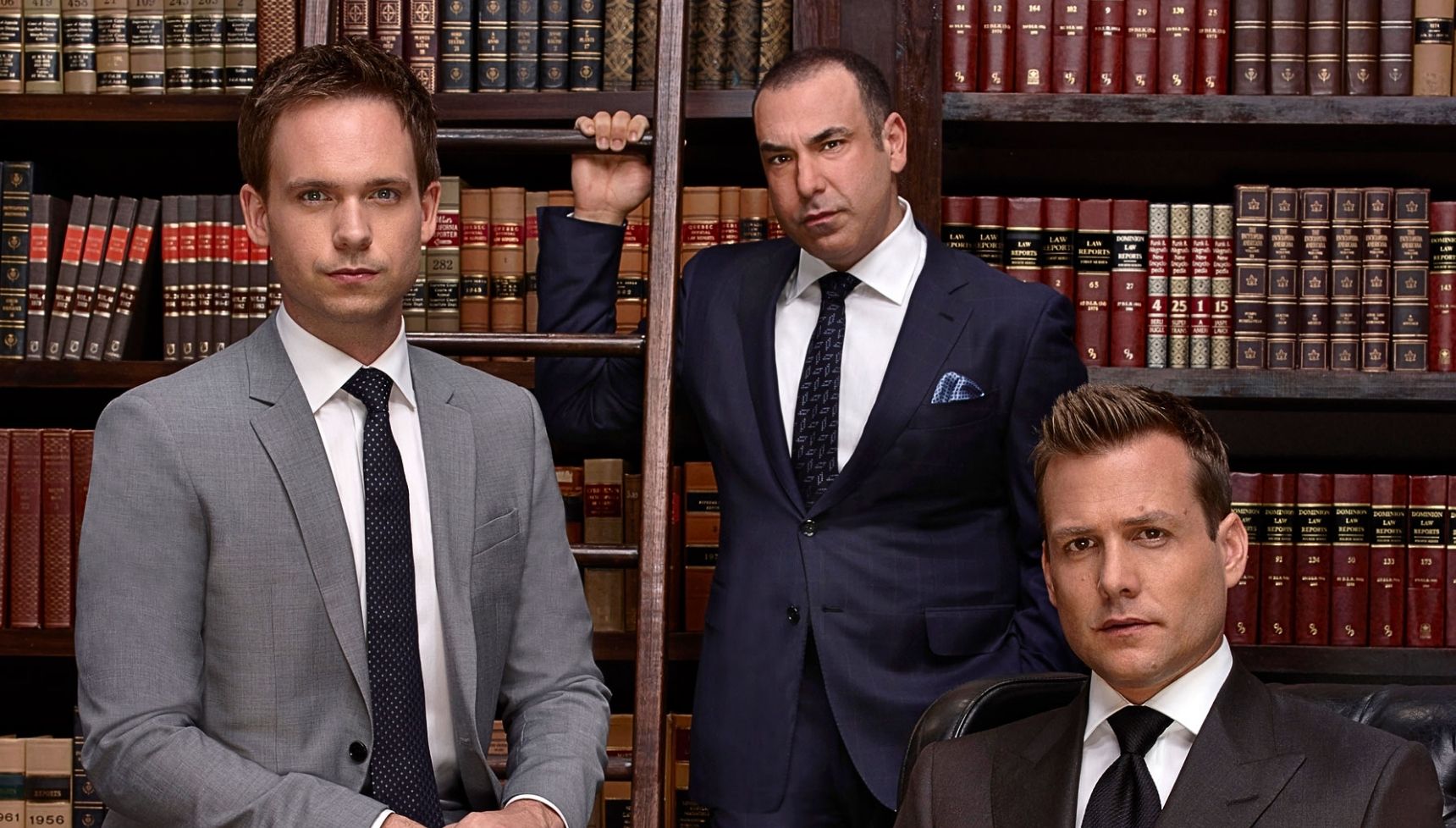 Mike Ross, Louis Litt, and Harvey Specter in a library in Suits