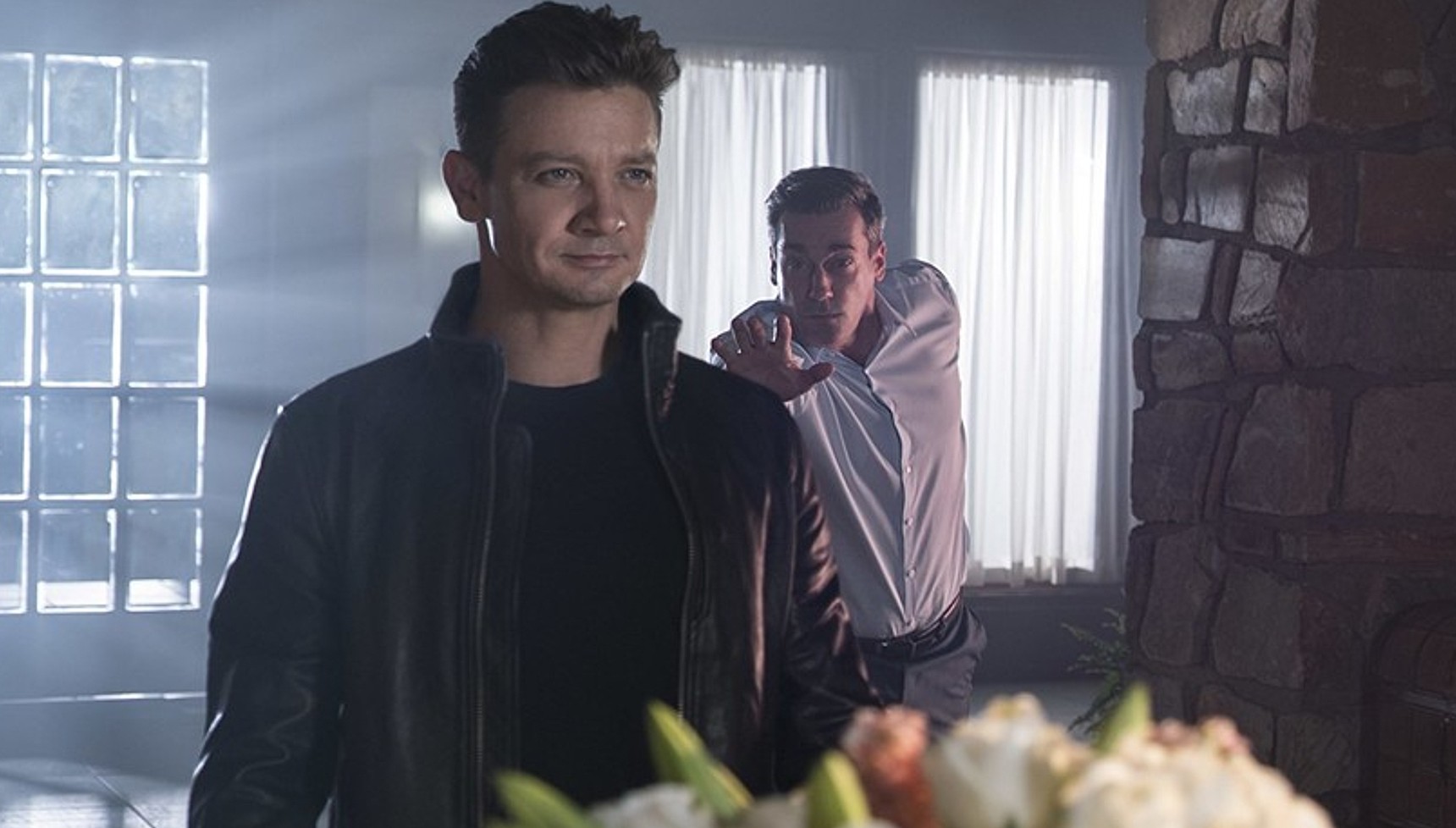 Jon Hamm reaching for Jeremy Renner in Tag