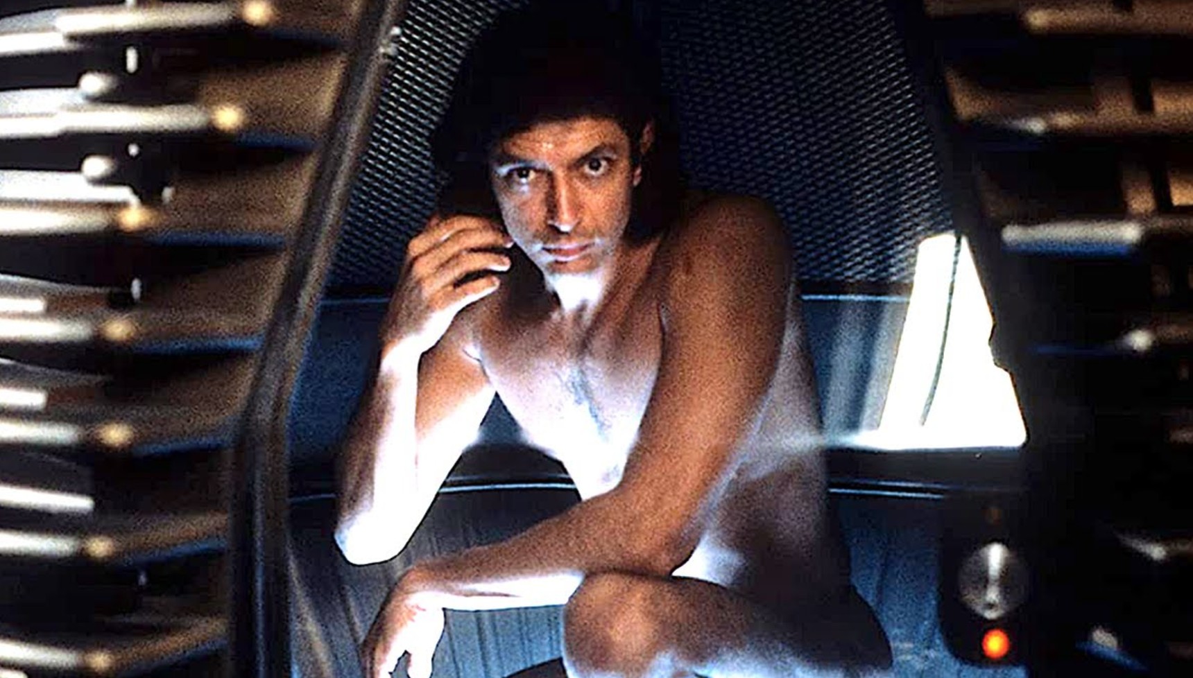 Jeff Goldblum kneeling in a teleportation pod in The Fly