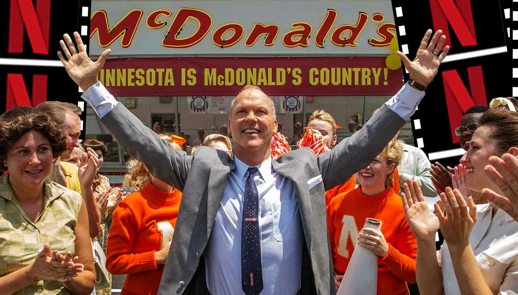 Michael Keaton holding his hands up in front of a McDonald's sign