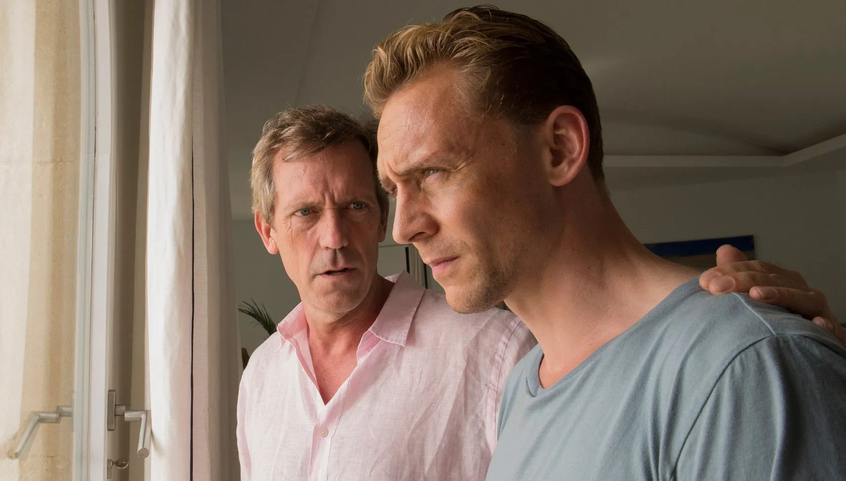 Hugh Laurie with his hand on Tom Hiddleston's shoulder in The Night Manager