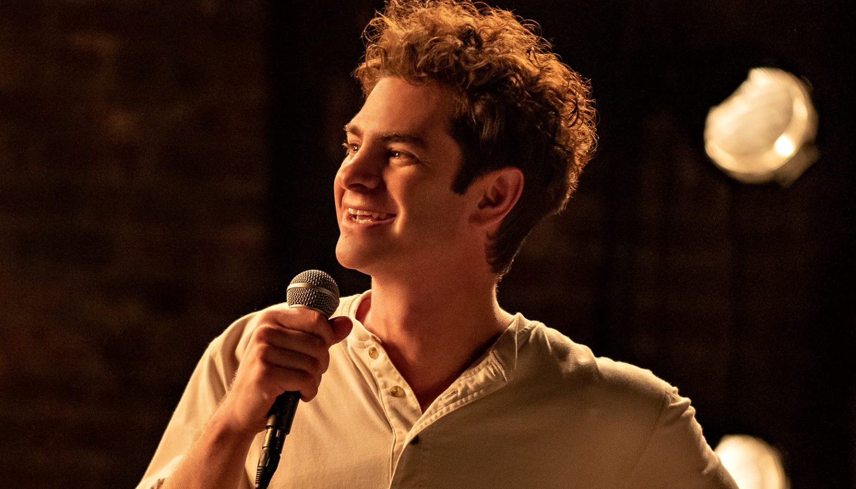 Andrew Garfield holding a microphone in Tick Tick Boom