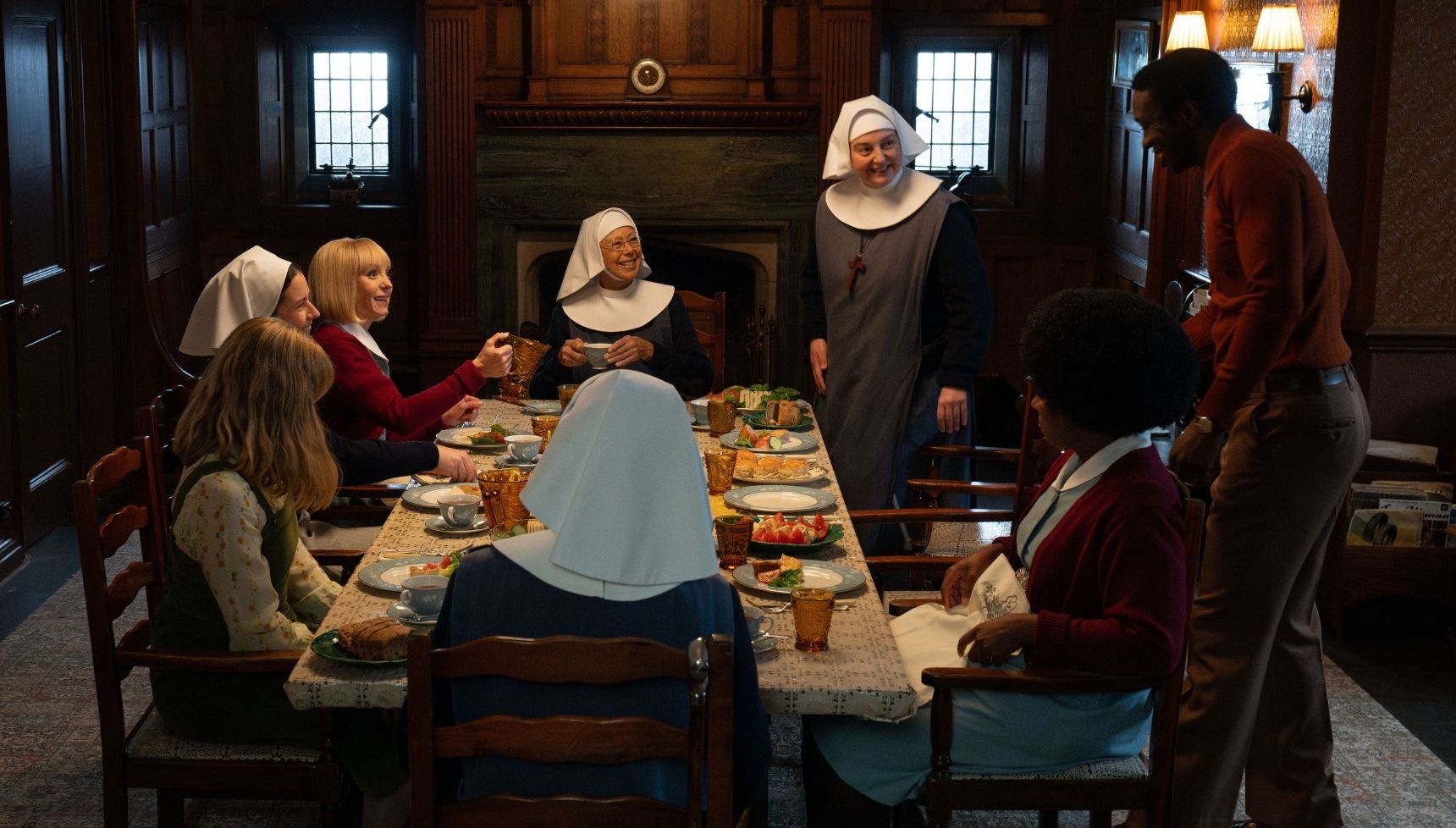 The residents of Nonnatus House sitting around the dinner table