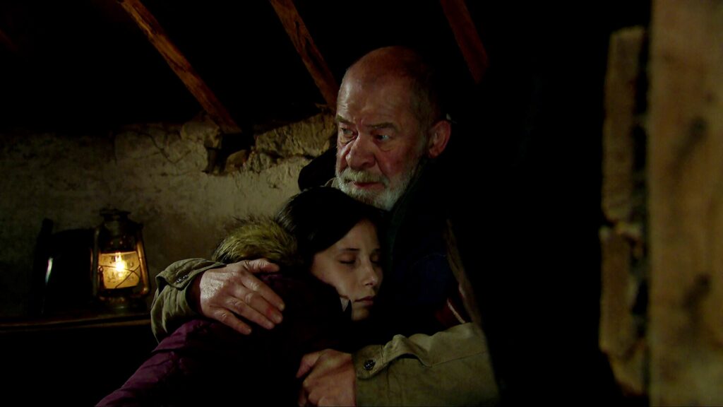 Anya lying in Bear's arms