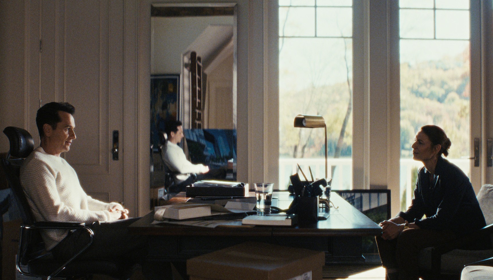 Nile and Aggie sit across from each other in The Beast in Me